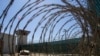 FILE - In this April 17, 2019, photo, reviewed by U.S. military officials, the control tower is seen through the razor wire inside the Camp VI detention facility in Guantanamo Bay Naval Base, Cuba. 