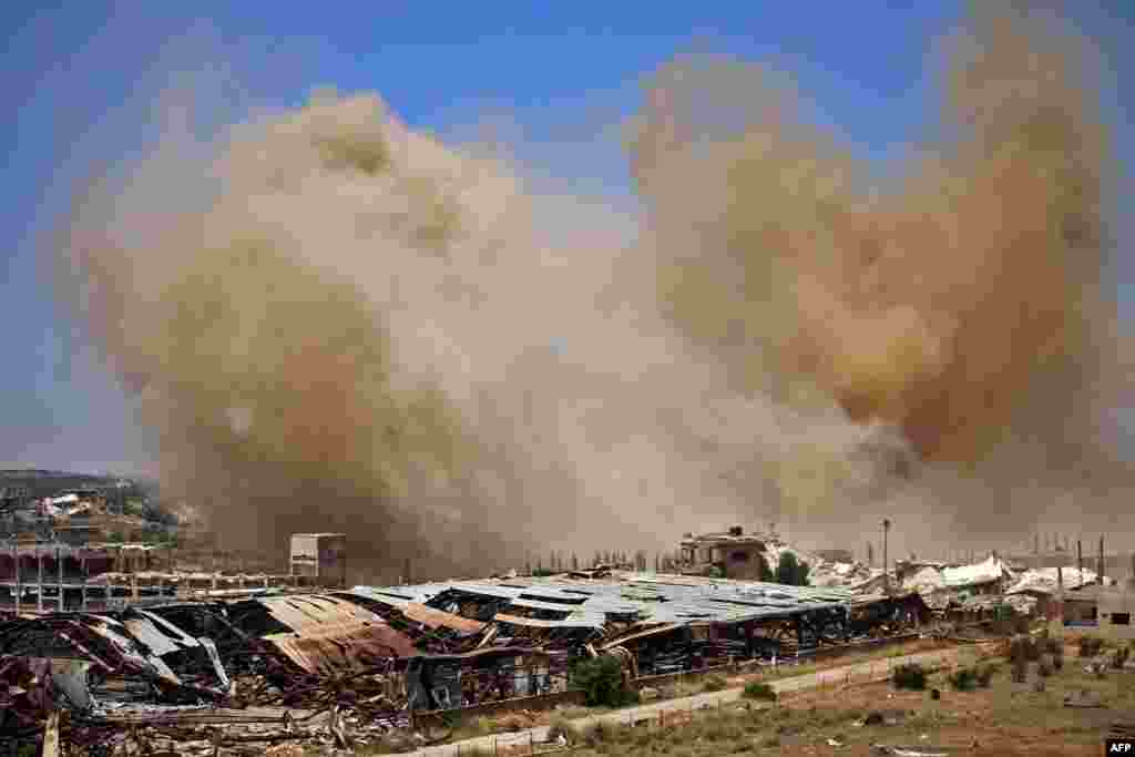 Smoke rises above opposition-held areas of the Daraa province countryside during airstrikes by Syrian regime forces.