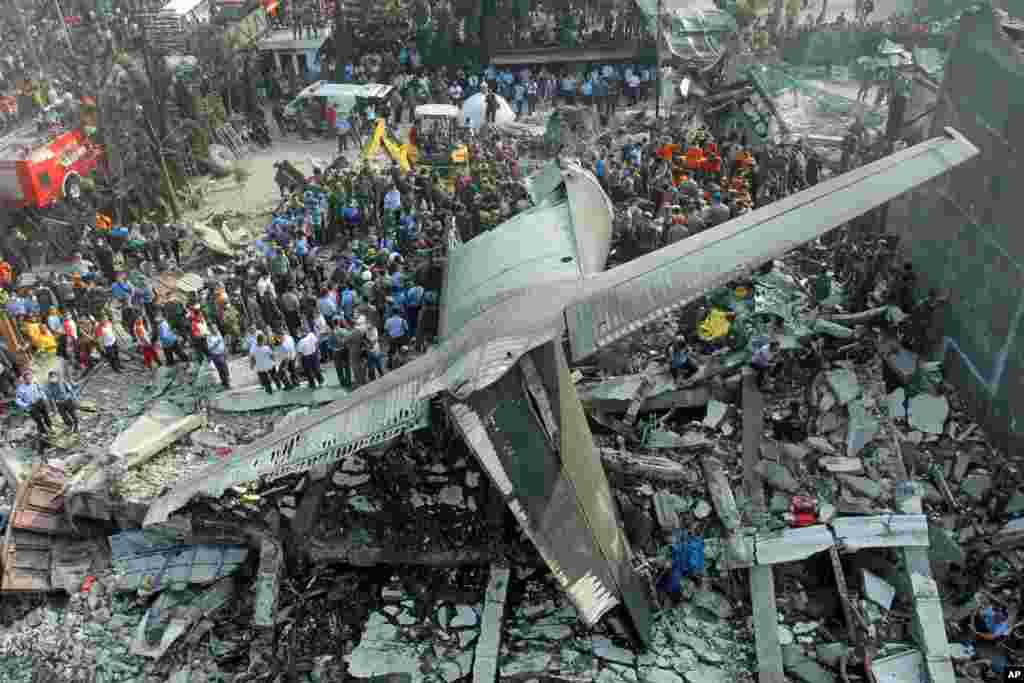 Rescuers search for victims at the site where an air force cargo plane crashed into a residential neighborhood in Indonesia&#39;s third-largest city Medanin Medan, North Sumatra.