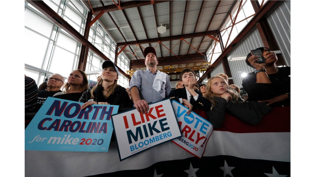 People listen as Democratic presidential candidate and former New York City Mayor Mike Bloomberg speaks at a campaign event in Raleigh, North Carolina, Feb. 13, 2020.