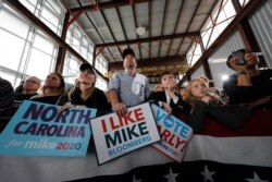 People listen as Democratic presidential candidate and former New York City Mayor Mike Bloomberg speaks at a campaign event in Raleigh, North Carolina, Feb. 13, 2020.