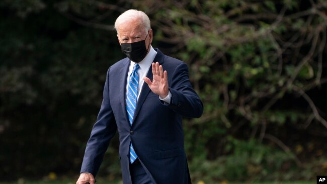 FILE - President Joe Biden walks to board Marine One on White House grounds, in Washington, Oct. 7, 2021.