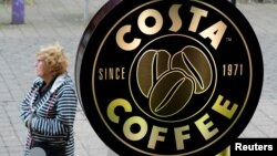 FILE - A woman walks past a Costa Coffee in Loughborough, Britain, April 25, 2018. 