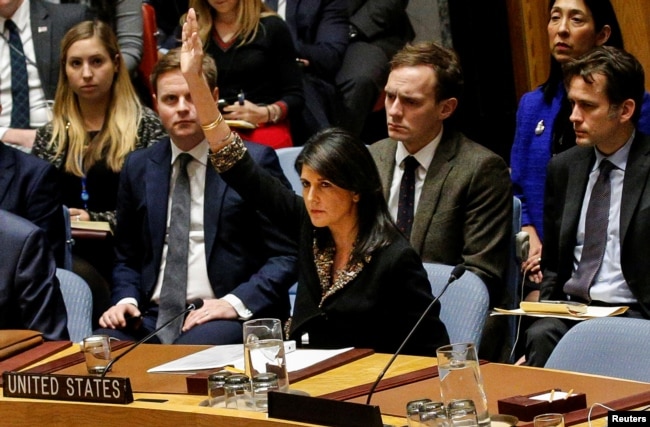 FILE - U.S. Ambassador to the United Nations Nikki Haley vetoes an Egyptian-drafted resolution regarding recent decisions concerning the status of Jerusalem, during a Security Council meeting on the situation in the Middle East, Dec. 18, 2017.