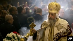 FILE - Coptic Pope Tawadros II leads Christmas Eve Mass at St. Mark's Cathedral, in Cairo, Egypt, Jan. 6, 2017. 