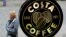FILE - A woman walks past a Costa Coffee in Loughborough, Britain, April 25, 2018. 