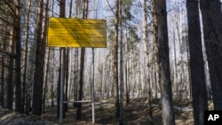 FILE - In this photo taken April 8, 2016, a sign warns people not to enter the town of Ozersk, Chelyabinsk region, Russia, which houses the Mayak nuclear facility. Mayak is a nuclear complex that has been responsible for at least two of the country’s biggest radioactive accidents.