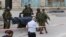 Israeli soldiers carry the dead body of one of two Palestinians, whom the Israeli military said were shot dead by Israeli troops after they attacked a soldier, in Tal Rumaida in the West Bank city of Hebron, March 24, 2016. 