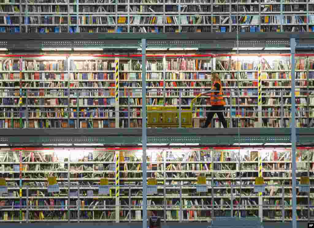 An employee works in the distribution center of the online retailer Amazon during a guided press tour prior to the upcoming Christmas shopping season in Leipzig, central Germany.