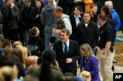 U.S. Sen. Michael Bennet, D-Colo., center, greets attendees during a community vigil to honor the victims and survivors of yesterday's fatal shooting at the STEM School Highlands Ranch, May 8, 2019, in Highlands Ranch, Colorado.