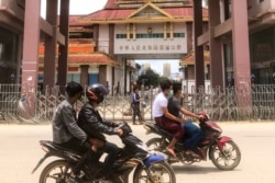 FILE - Motorists pass the China-Myanmar border gate in Muse in Shan state on July 5, 2021, as the Chinese city of Ruili near the border with Myanmar imposed a lockdown and started mass testing.