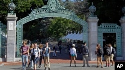 FILE - In this April 21, 2017 file photo, students walk past Sather Gate on the University of California, Berkeley campus in Berkeley, Calif. 