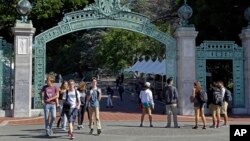 FILE - Students walk past Sather Gate on the University of California, Berkeley campus in Berkeley, Calif. 