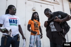 In exile since 2007, Sheriff Bojang Junior, far right, buys a "#Gambia Has Decided" T-shirt, hours after he returns home after former president Yahya Jammeh agreed to relinquish power to Adama Barrow, who won elections in December.