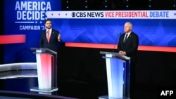 U.S. Senator and Republican vice presidential candidate J.D. Vance, left, and Minnesota Governor and Democratic vice presidential candidate Tim Walz participate in the debate hosted by CBS News in New York, Oct. 1, 2024. 