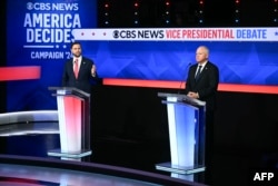 U.S. Senator and Republican vice presidential candidate JD Vance left, and Minnesota Governor and Democratic vice presidential candidate Tim Walz participate in a debate hosted by CBS News in New York, Oct. 1, 2024. During the debate, both were asked about climate change.