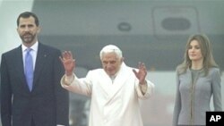 Pope Benedict XVI waves as he walks with Spanish Crown Prince Felipe and Princess Letizia upon arriving at Lavacolla airport in Santiago de Compostela, northern Spain, 06 Nov 2010