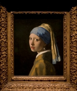 This reproduction shows Johannes Vermeer's Girl with a Pearl Earring (painted approximatetely 1665) at the renovated Mauritshuis museum during a preview for the press in The Hague, Netherlands, Friday, June 20, 2014.