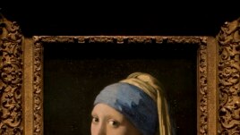 This reproduction shows Johannes Vermeer's Girl with a Pearl Earring (painted approximatetely 1665) at the renovated Mauritshuis museum during a preview for the press in The Hague, Netherlands, Friday, June 20, 2014.