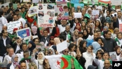 Algerians, many of them medical professionals and students, march with banners and flags during an anti-government protest in Algiers, Algeria, March 19, 2019.