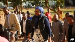 Zimbabwe tourism and environment minister Prisca Mupfumira, center, arrives at court in Harare, July 26, 2019.