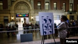 A woman reads an Ebola alert at Bellevue Hospital, where Dr. Craig Spencer is being treated for symptoms in New York Oct. 23, 2014. 