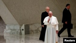 Pope Francis greets people as he arrives at Aula Paolo VI for the weekly general audience at the Vatican, Oct. 28, 2020. 