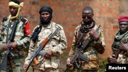 Seleka fighters warily eye a photographer at their base in Bambari, Central African Republic, on May 31, 2014. 