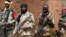 Seleka fighters warily eye a photographer at their base in Bambari, Central African Republic, on May 31, 2014. 