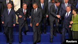 China's President Xi Jinping, U.N. Secretary-General Ban Ki-moon, U.S. President Barack Obama, Netherlands' P.M. Mark Rutte, Kazakhstan's President Nursultan Nazarbayev and South Korea's President Park Geun-hye (L-R) take part in a photo with other world leaders at the Nuclear Security Summit in The Hague, March 25, 2014.