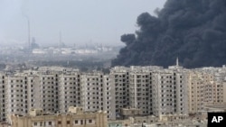 Black smoke is seen from Homs refinery, Syria, December 8, 2011.