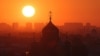 The sun rises behind the Church of the Dormition of the Mother of God in Saint Petersburg, Russia, July 17, 2024. 