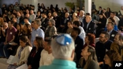 Guests listen to speakers during a Chicanukah event at the Holocaust Museum Houston, in Houston, Texas, Dec. 19, 2024.