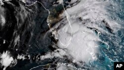 In this image released by NOAA's GOES-16 on Sept. 3, 2018, Tropical Storm Gordon appears south of Florida. The storm is expected to cross from southwest Florida into the Gulf Coast.