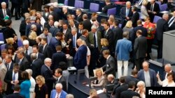 Deputies vote during the session of Germany's parliament, the Bundestag, in Berlin, Germany, July 17, 2015.