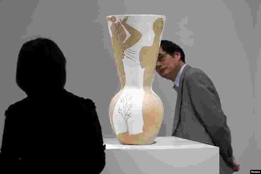 People look at Pablo Picasso's "Grand vase aux danseurs" during a media preview of Christie's Shanghai Spring Auction in Shanghai, China.
