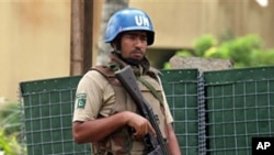 A UN soldier stands guard outside the Golf Hotel in Abidjan, 30 Dec 2010