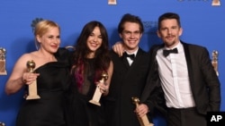 Patricia Arquette, from left, Lorelei Linklater, Ellar Coltrane, and Ethan Hawke pose in the press room with the award for best motion picture - drama for “Boyhood” at the 72nd annual Golden Globe Awards at the Beverly Hilton Hotel on Sunday, Jan. 11, 201