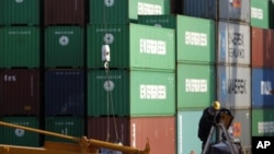 A man works at a container area at a port in Tokyo January 25, 2012.