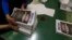 Pressroom workers pack an edition of the newspaper Danas in Belgrade, Serbia, Sept. 27, 2017. The paper bears a white inscription that warns: "This is what it looks like when there is no free press!" 
