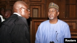 Charged with illegal possession of weapons and acts that pose potential harm to national security, gormer National Security Adviser Sambo Dasuki, right, arrives at the Federal High Court in Abuja, Nigeria, Sept. 1, 2015.