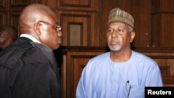 Former National Security Adviser Sambo Dasuki (R) arrives with one of his counsels Ahmed Raji at the Federal High Court in Abuja, Nigeria, Sept. 1, 2015. 