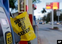 A gas pump is covered after a gas station ran out of gas, Sept. 7, 2017, in Miami.