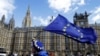 An anti-Brexit campaigner shows her support for Europe waving a European Union flag outside Parliament in London, March 25, 2019. 