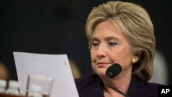 FILE - Democratic presidential candidate, former Secretary of State Hillary Rodham Clinton looks at an email sent by Ambassador Chris Stevens during her testimony before the House Benghazi Committee.