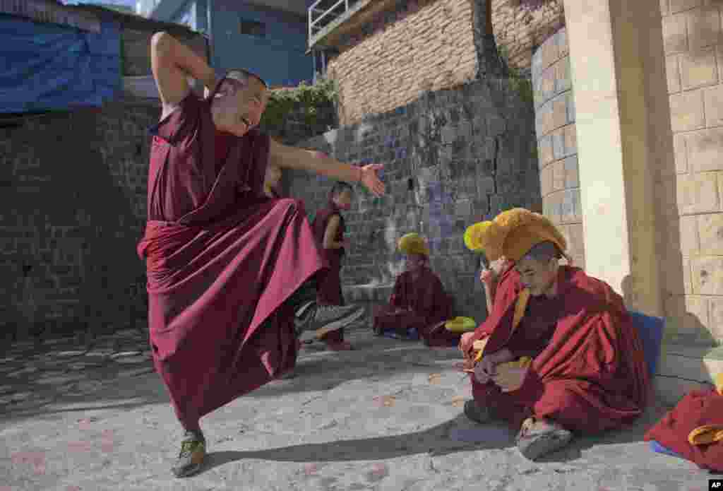 An exiled Tibetan monk participates in a dialectics debate with another monk at the Kirti monastery in Dharmsala, India.