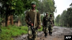 M23 rebel group soldiers patrol in Rangira, near Rutshuru, DRC, October 17, 2012.