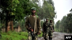 M23 rebel group soldiers patrol in Rangira, near Rutshuru, DRC, October 17, 2012.