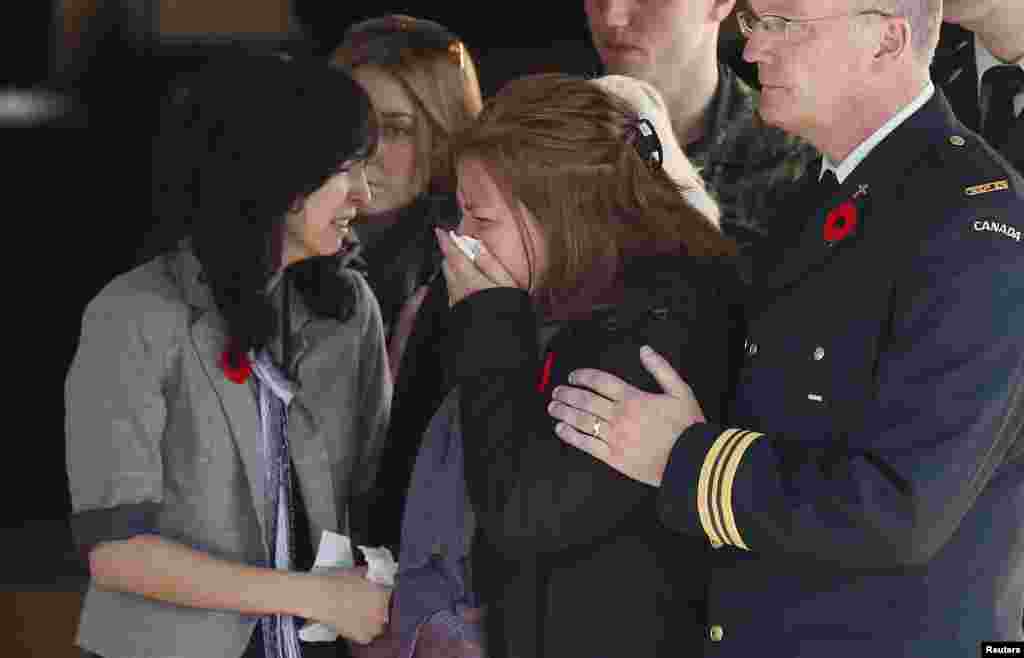 Kathy Cirillo, the mother of Cpl. Nathan Cirillo, the serviceman who was killed when a gunman attacked multiple locations in downtown Ottawa, reacts as his casket is placed in a hearse at a funeral home in Ottawa, Canada, Oct. 24, 2014. 