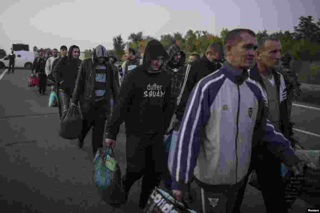 Pro-Russian POW wait to be exchanged, north of Donetsk, eastern Ukraine, Sept. 28, 2014.